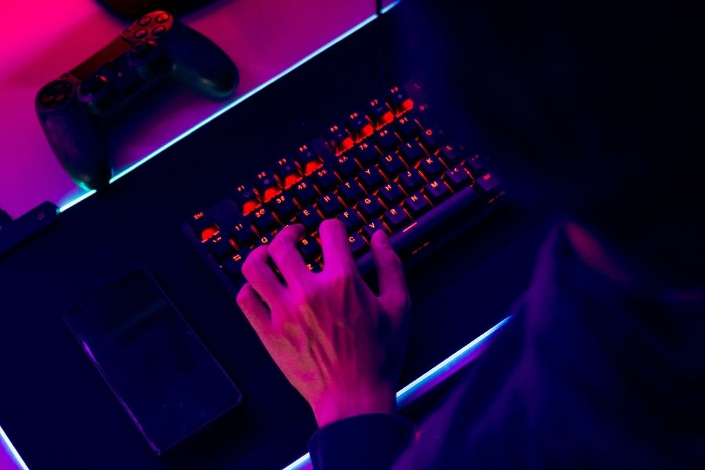 A Professional Gamer is playing a game on Mechanical Keyboard.