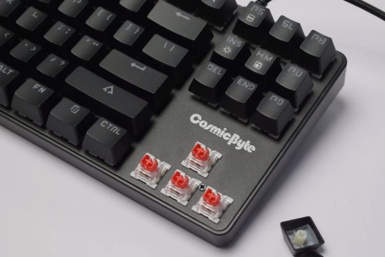 Red Outemu switches are visible from the naked arrow keys of the mechanical keyboard.