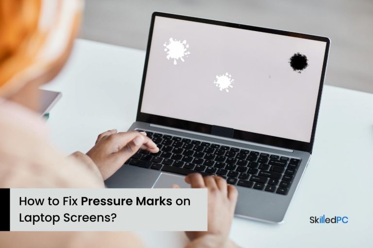 A laptop screen has a dead pixel and pressure marks.