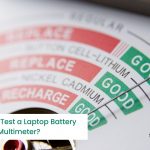 A multimeter tests the health of a laptop battery.