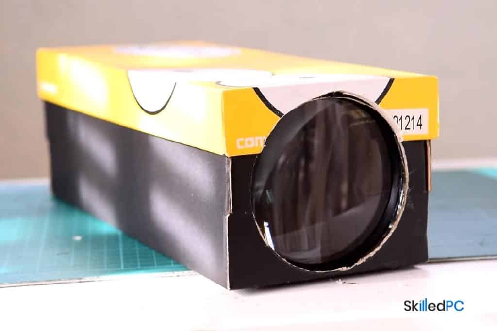 A black shoebox with magnifying glass.